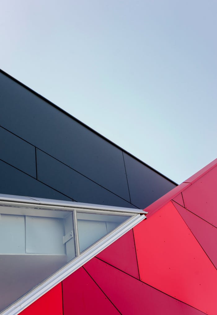 About A low-angle view of a modern geometric building facade with bold colors in London, ON, Canada.